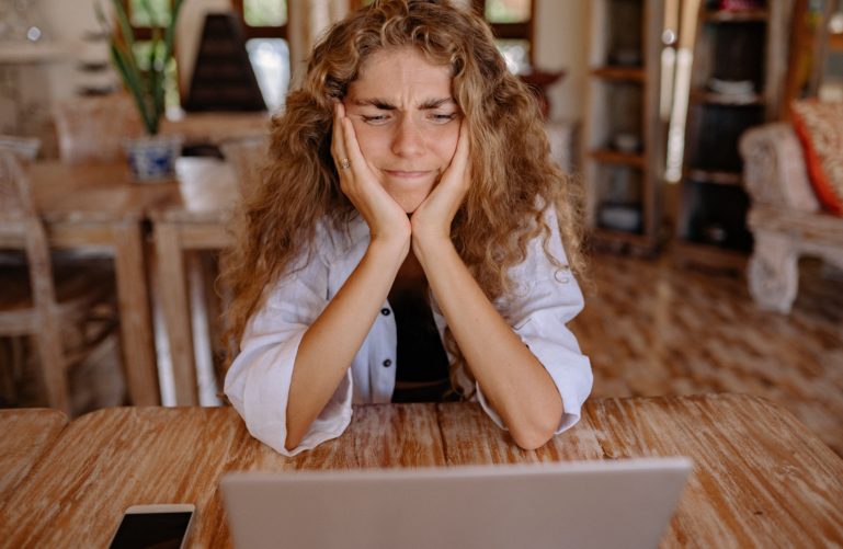 Frustrated small business woman with red hair frustrated with WordPress website maintenance