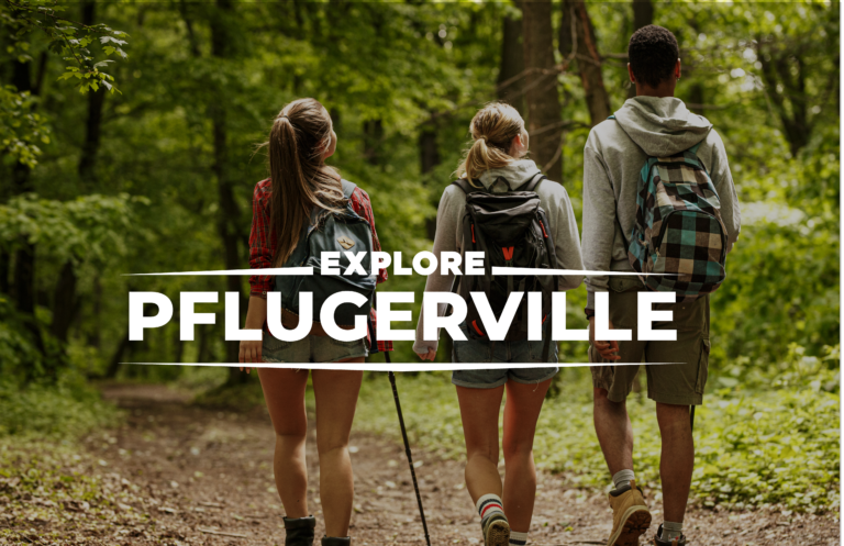 Three people walking in the woods with backpacks