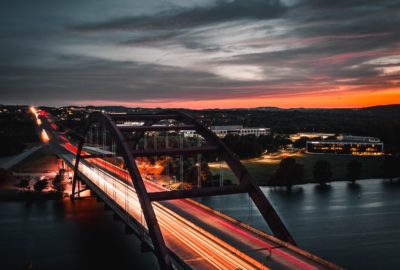 a long exposure photo of a bridge at night