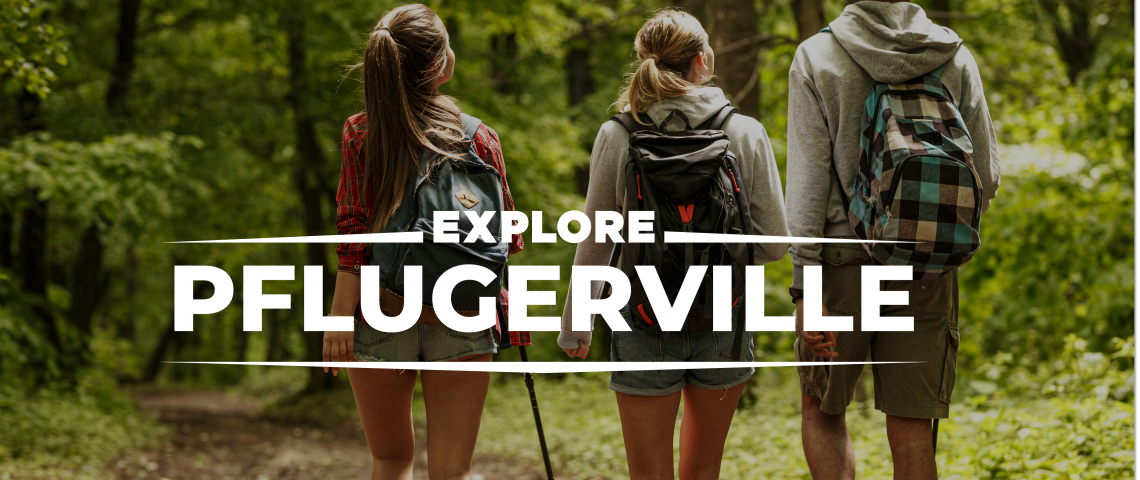 three people walking in the woods with backpacks