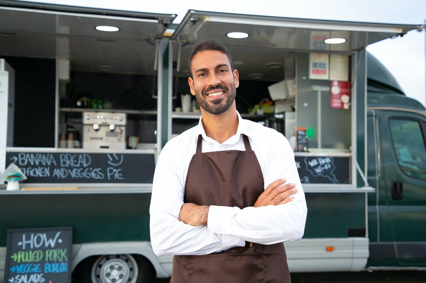 A man standing in front of a food truck