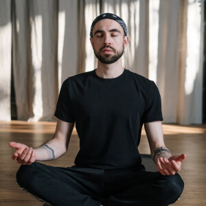 a man sitting in the middle of a yoga pose
